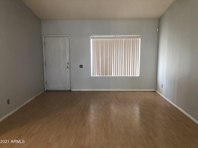 4042 E Carson Rd, Phoenix, AZ 85042 - unfurnished room featuring wood finished floors and plenty of natural light