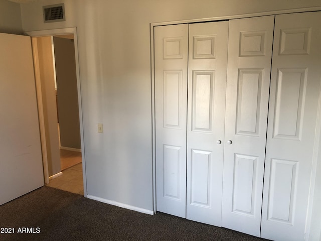 4042 E Carson Rd, Phoenix, AZ 85042 - unfurnished bedroom with carpet floors, a closet, and tile patterned floors