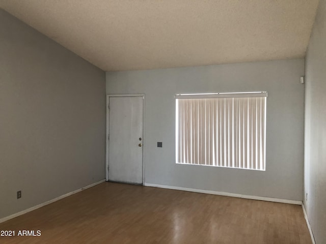 4042 E Carson Rd, Phoenix, AZ 85042 - unfurnished room with wood finished floors and baseboards