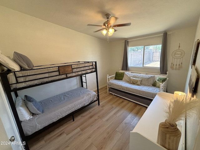 bedroom with light wood-style floors and a ceiling fan