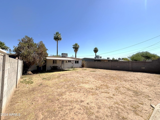 view of yard with cooling unit and a fenced backyard