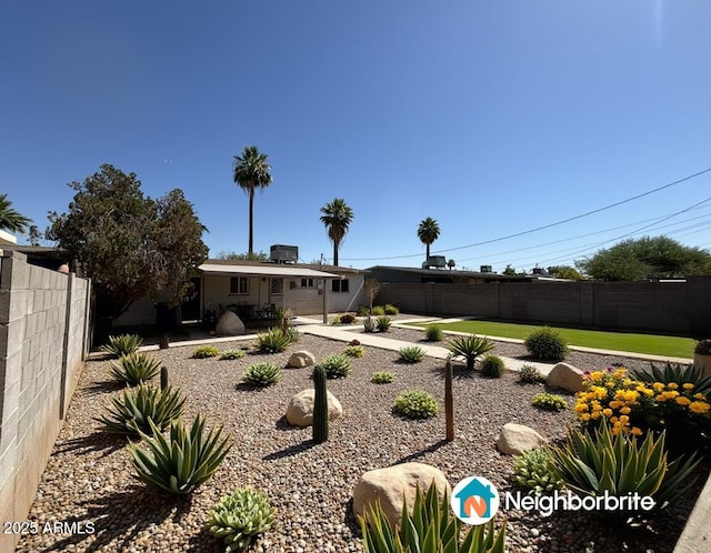 back of property featuring a fenced backyard