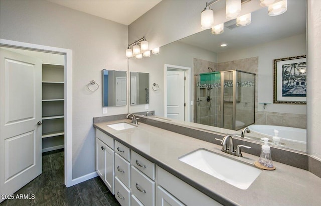 7769 E Lavender Loop, Prescott Valley, AZ 86315 - full bathroom featuring a shower stall, double vanity, a garden tub, and a closet