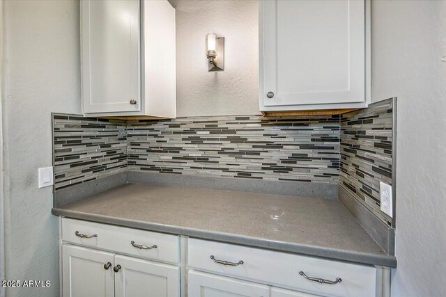 7769 E Lavender Loop, Prescott Valley, AZ 86315 - kitchen with white cabinetry and decorative backsplash