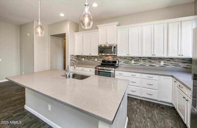 7769 E Lavender Loop, Prescott Valley, AZ 86315 - kitchen with stainless steel appliances, a sink, decorative backsplash, white cabinets, and recessed lighting