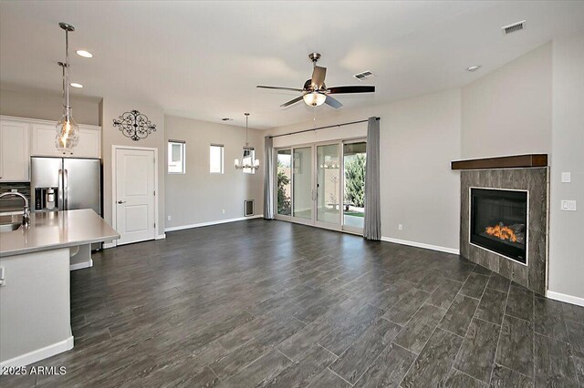 7769 E Lavender Loop, Prescott Valley, AZ 86315 - unfurnished living room featuring a ceiling fan, a tile fireplace, baseboards, recessed lighting, and dark wood-style floors