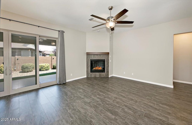 7769 E Lavender Loop, Prescott Valley, AZ 86315 - unfurnished living room with dark wood-type flooring, ceiling fan, baseboards, and a tile fireplace