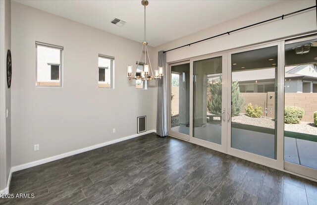 7769 E Lavender Loop, Prescott Valley, AZ 86315 - unfurnished dining area with dark wood-type flooring, a chandelier, healthy amount of natural light, and baseboards