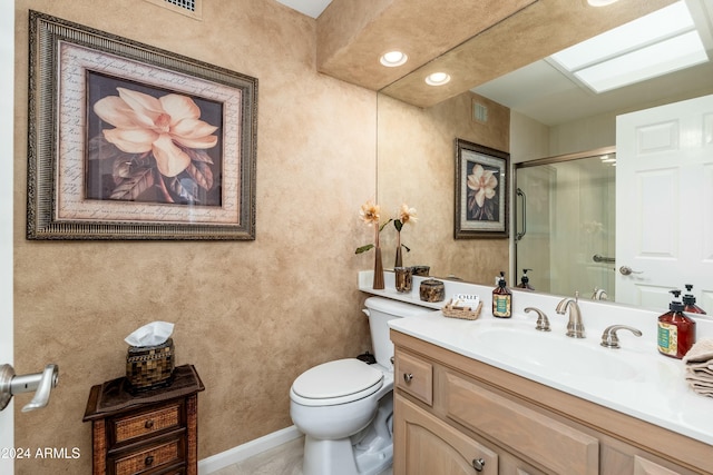 bathroom featuring vanity, toilet, and an enclosed shower