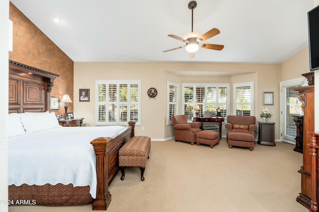 bedroom featuring light colored carpet, multiple windows, lofted ceiling, and ceiling fan