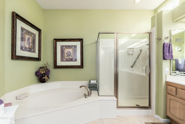 bathroom featuring tile patterned flooring, vanity, and shower with separate bathtub