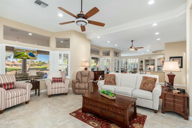 tiled living room featuring ceiling fan