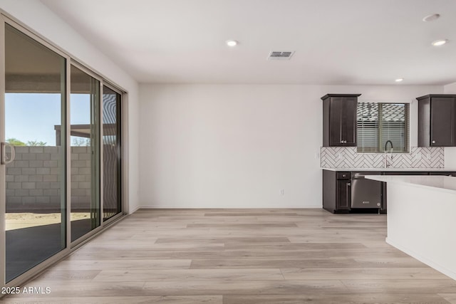 interior space featuring a sink, visible vents, recessed lighting, and light wood-type flooring