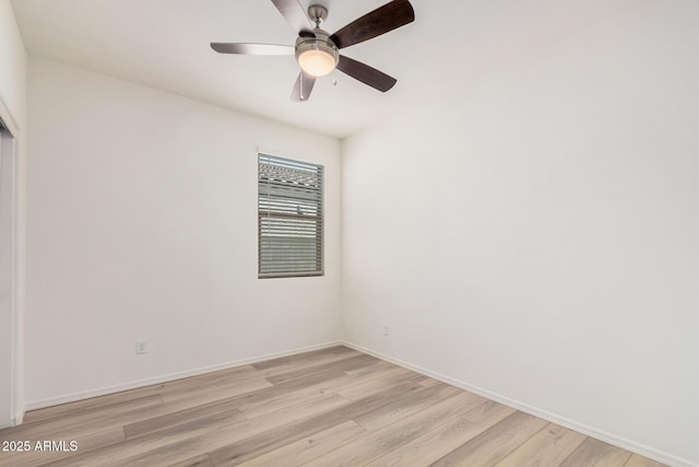 spare room with light wood finished floors, baseboards, and ceiling fan