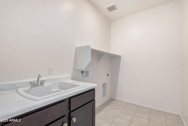 washroom featuring visible vents, washer hookup, a sink, hookup for an electric dryer, and cabinet space