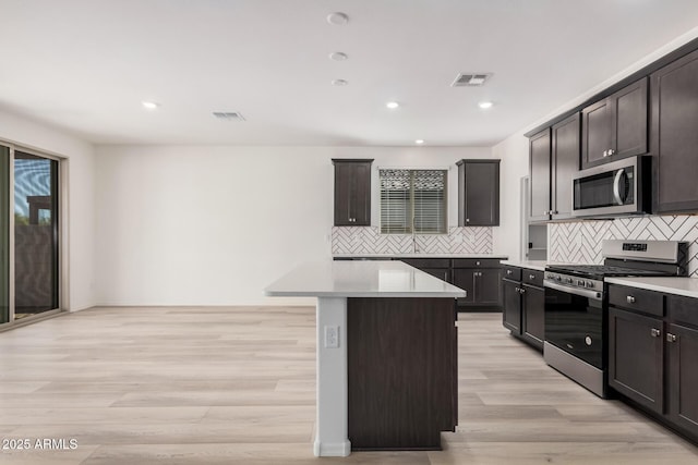 kitchen featuring light countertops, visible vents, stainless steel appliances, and light wood-type flooring