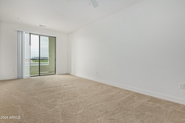 spare room with ceiling fan and carpet floors