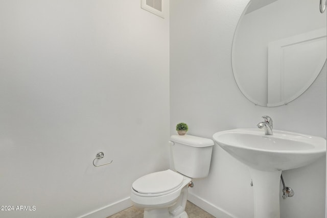 bathroom with toilet and tile flooring