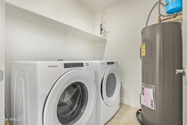 laundry room featuring light tile floors, gas water heater, and washer and clothes dryer