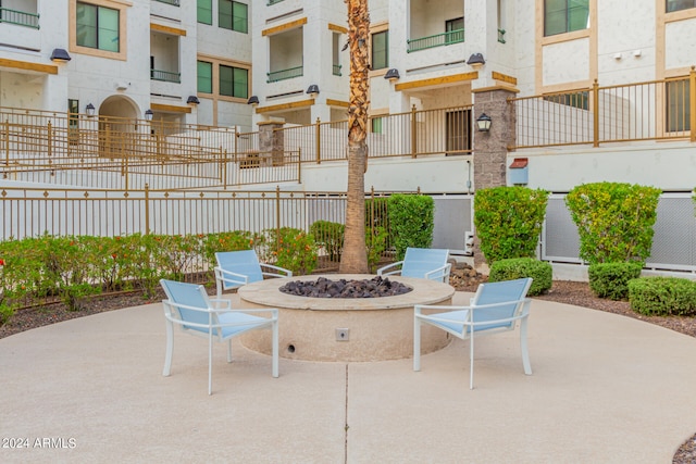 view of patio / terrace featuring a fire pit and a balcony