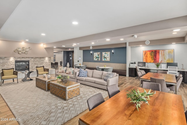 living room with light hardwood / wood-style flooring and a fireplace