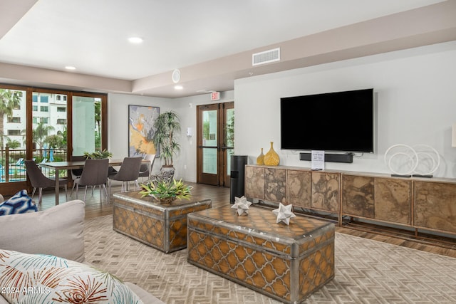 living room featuring wood-type flooring and french doors