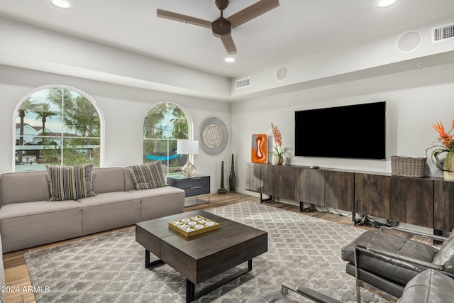 living room featuring wood-type flooring and ceiling fan