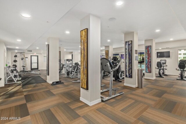 workout area featuring dark colored carpet