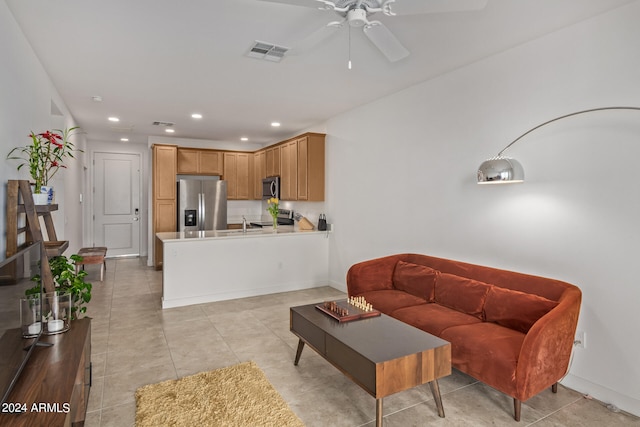 tiled living room featuring ceiling fan