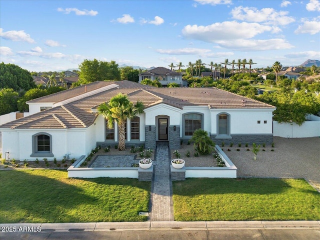 3354 E Jaeger Cir, Mesa, AZ 85213 - mediterranean / spanish-style home with stucco siding, a tile roof, a fenced front yard, and a residential view