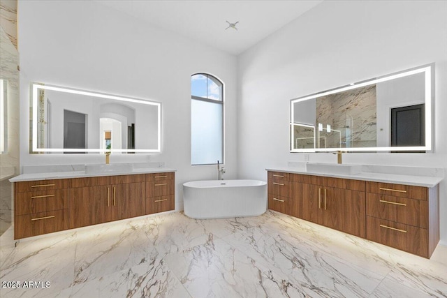 3354 E Jaeger Cir, Mesa, AZ 85213 - bathroom with marble finish flooring, two vanities, a soaking tub, a marble finish shower, and vaulted ceiling