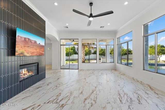 3354 E Jaeger Cir, Mesa, AZ 85213 - unfurnished living room featuring ceiling fan, ornamental molding, a glass covered fireplace, recessed lighting, and arched walkways