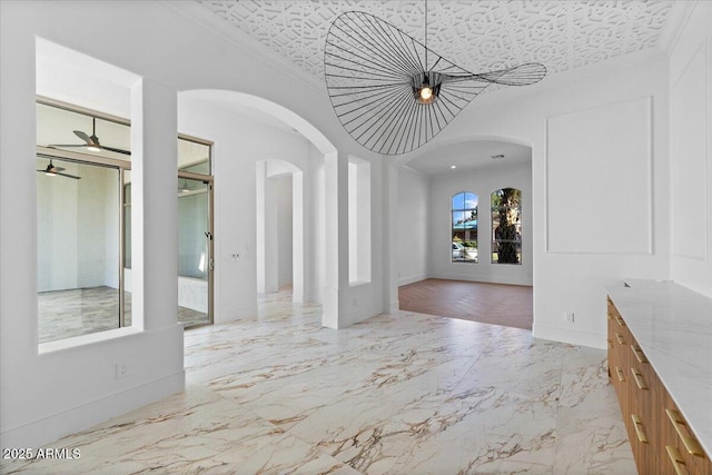 3354 E Jaeger Cir, Mesa, AZ 85213 - interior space with light marble finish flooring, arched walkways, crown molding, ceiling fan, and an ornate ceiling