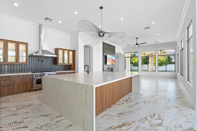 3354 E Jaeger Cir, Mesa, AZ 85213 - kitchen with designer range, exhaust hood, brown cabinets, recessed lighting, and arched walkways