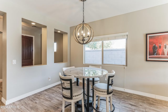 dining room with a chandelier and hardwood / wood-style floors