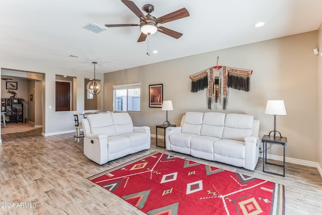 living room with hardwood / wood-style flooring and ceiling fan