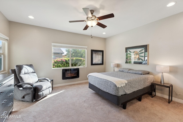 bedroom featuring heating unit, ceiling fan, and light carpet