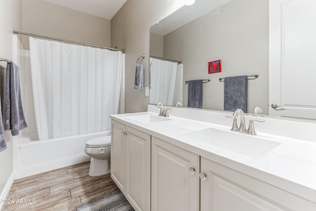 full bathroom featuring hardwood / wood-style floors, vanity, toilet, and shower / bath combination with curtain