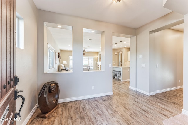 spare room featuring ceiling fan, sink, and light hardwood / wood-style floors