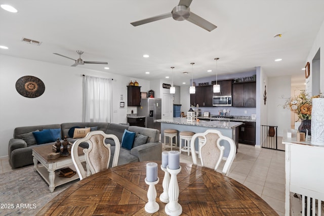 dining room featuring ceiling fan and light tile patterned flooring