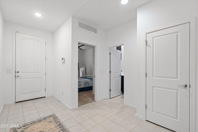 corridor featuring light tile patterned floors