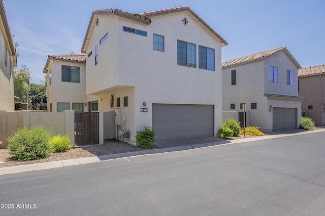 3451 S Wren Dr, Gilbert, AZ 85297 - mediterranean / spanish-style home featuring a garage, a tile roof, stucco siding, and a gate