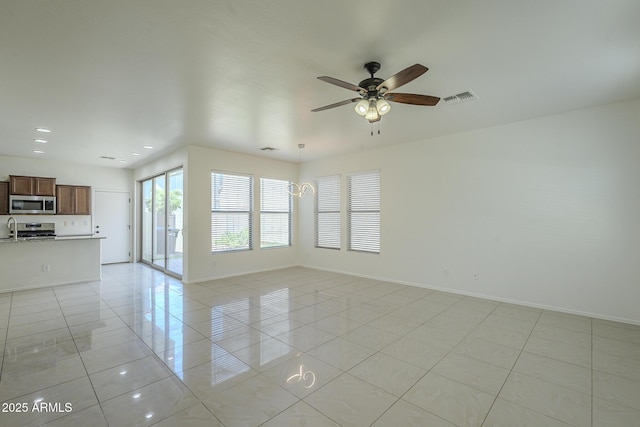 3451 S Wren Dr, Gilbert, AZ 85297 - unfurnished living room with light tile patterned floors, a ceiling fan, and recessed lighting