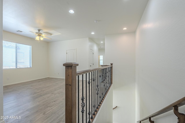 3451 S Wren Dr, Gilbert, AZ 85297 - hallway with an upstairs landing, light wood finished floors, and recessed lighting