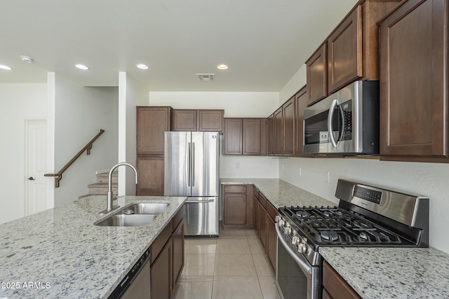 3451 S Wren Dr, Gilbert, AZ 85297 - kitchen with appliances with stainless steel finishes, light stone countertops, light tile patterned flooring, and recessed lighting