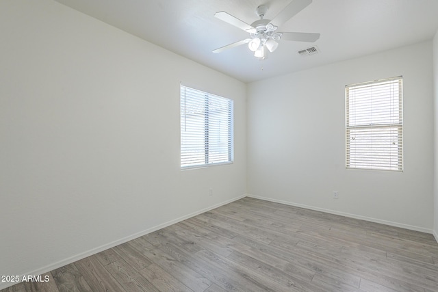 3451 S Wren Dr, Gilbert, AZ 85297 - unfurnished room featuring healthy amount of natural light, light wood finished floors, and ceiling fan