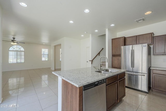 3451 S Wren Dr, Gilbert, AZ 85297 - kitchen with appliances with stainless steel finishes, light tile patterned flooring, a ceiling fan, open floor plan, and a kitchen island with sink