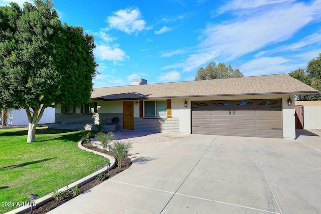 ranch-style home with a garage and a front lawn