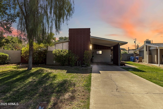 1329 E Catalina Dr, Phoenix, AZ 85014 - contemporary house featuring a lawn, fence, driveway, and an attached carport