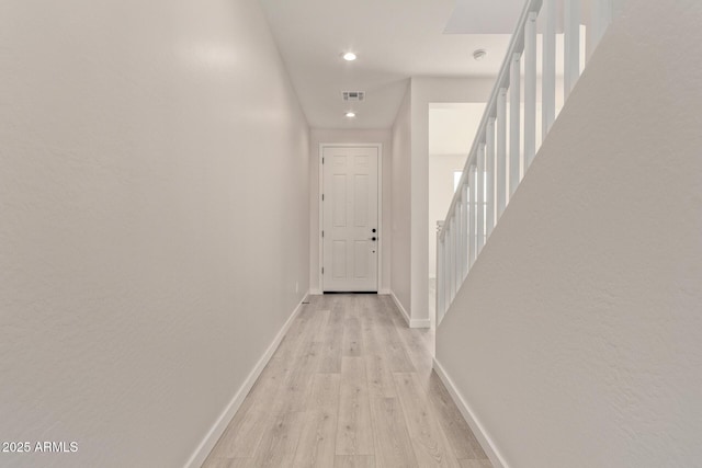 hall with light hardwood / wood-style floors